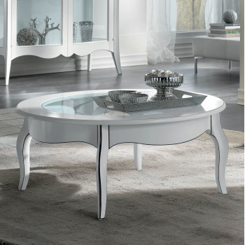 Tavolino rotondo con piano in vetro, ambientato