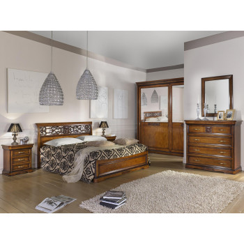 Camera da letto con armadio a specchi e letto intagliato