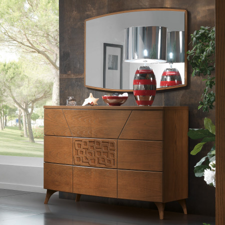 Comò 3 cassetti push-pull con formella traforata e piedi in legno in ambiente moderno