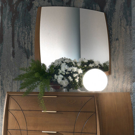 Specchiera sagomata con cornice in legno su comò