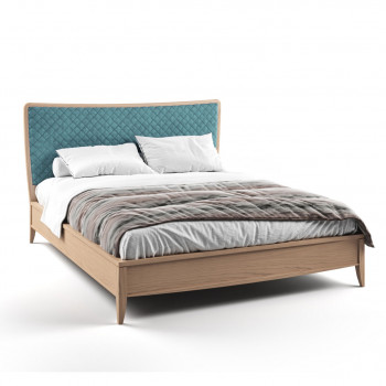 Letto in legno con testata imbottita blu trapuntata
