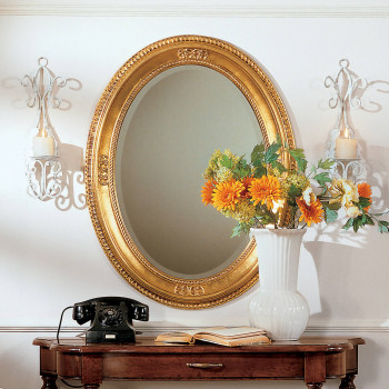 Specchiera ovale cornice foglia oro su parete decorativa
