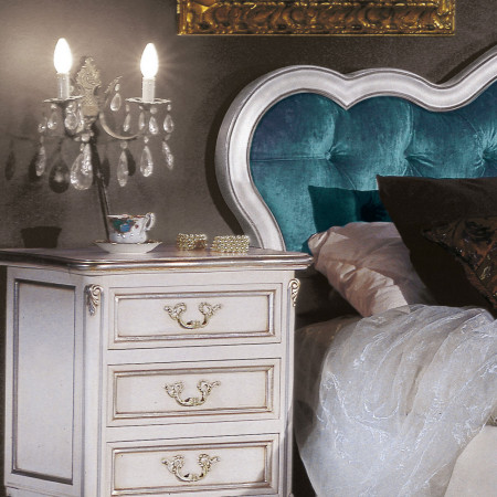 Comodino 3 cassetti con particolari intagliati, elegante ambiente